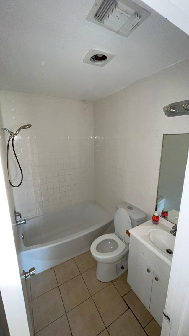 full bathroom with tile patterned floors, vanity, toilet, and tiled shower / bath