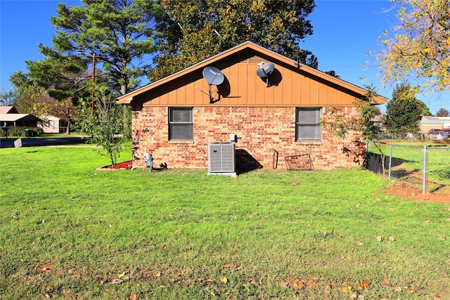 view of home's exterior featuring cooling unit and a yard