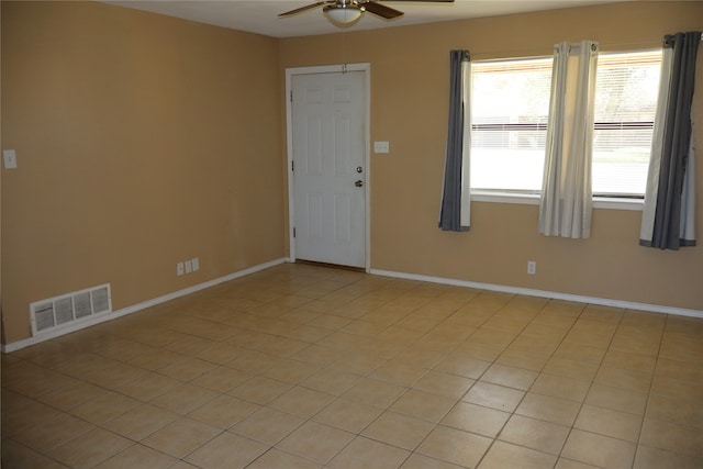 tiled empty room with ceiling fan