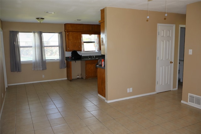 kitchen featuring sink and light tile patterned flooring