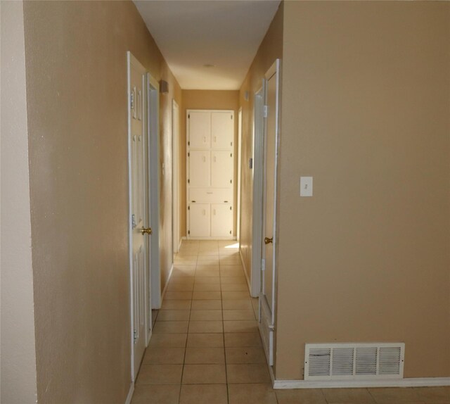 hall featuring light tile patterned flooring