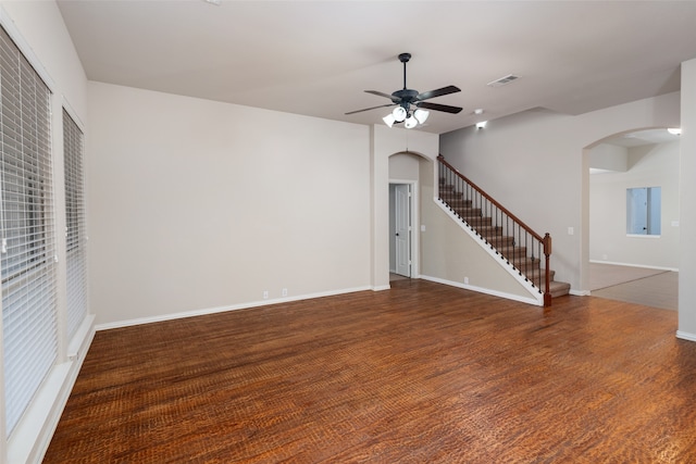 unfurnished living room with ceiling fan and dark hardwood / wood-style floors