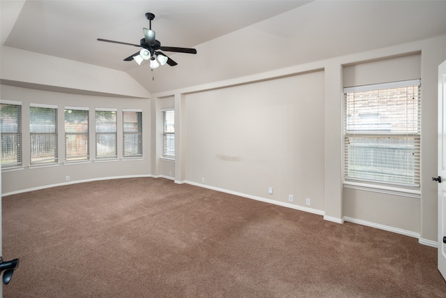 carpeted spare room with ceiling fan and vaulted ceiling