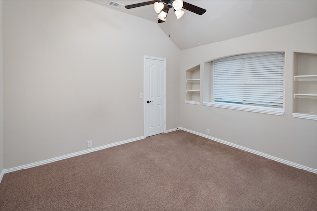 spare room featuring ceiling fan, built in features, carpet floors, and lofted ceiling