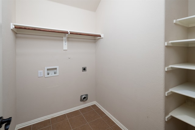 clothes washing area with electric dryer hookup, gas dryer hookup, hookup for a washing machine, and dark tile patterned floors