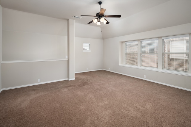 carpeted spare room featuring ceiling fan and vaulted ceiling