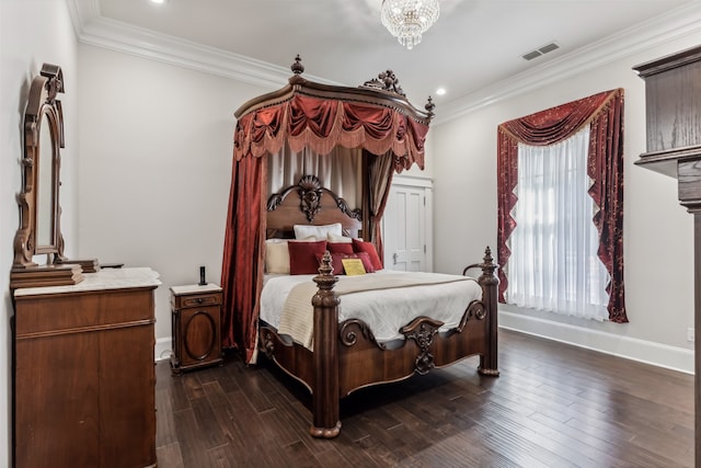 bedroom with dark wood-type flooring, ornamental molding, and a chandelier