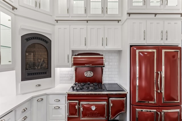 kitchen with refrigerator, decorative backsplash, and white cabinets