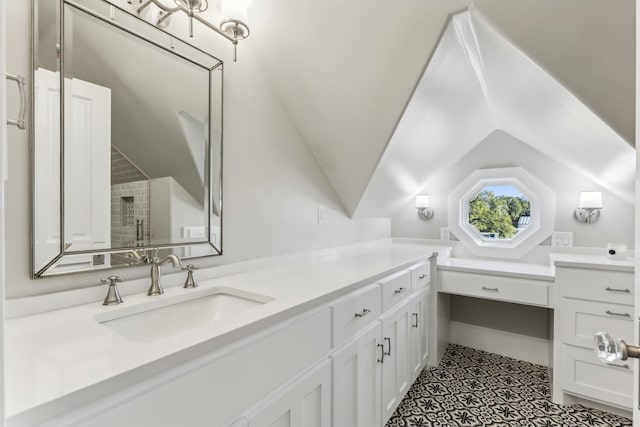 bathroom with vanity and lofted ceiling