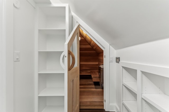 interior space featuring wood-type flooring and vaulted ceiling