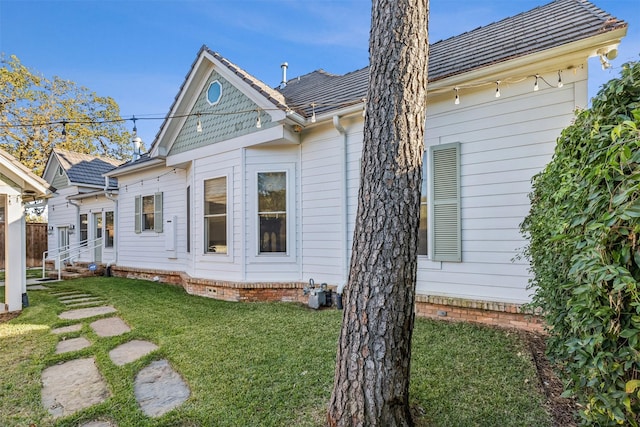 rear view of property with a yard