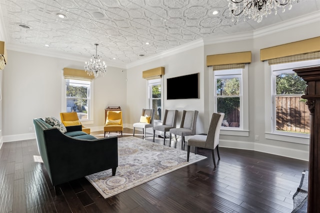 living room featuring crown molding, a healthy amount of sunlight, a notable chandelier, and dark hardwood / wood-style flooring