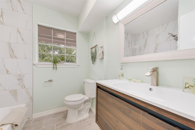 bathroom featuring vanity and toilet