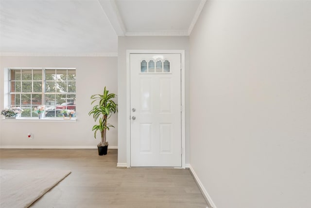 foyer with crown molding and light wood-type flooring