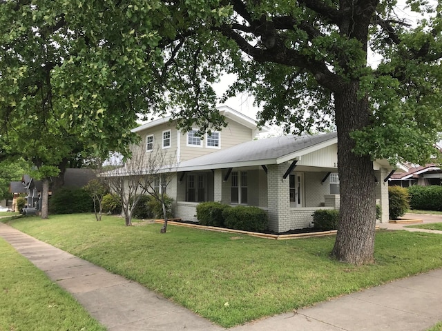 view of front of house with a front yard and a porch