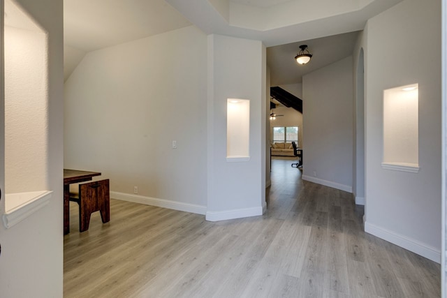 hall featuring lofted ceiling and light wood-type flooring