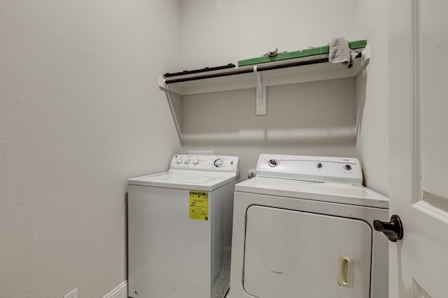 laundry room with washing machine and clothes dryer