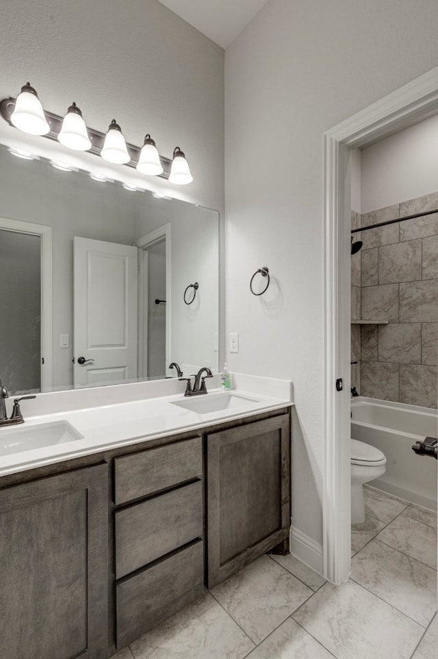 full bathroom featuring vanity, toilet, and tiled shower / bath