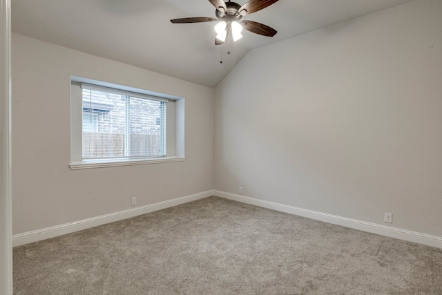 carpeted empty room with vaulted ceiling and ceiling fan