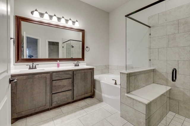 bathroom with vanity, shower with separate bathtub, and tile patterned flooring