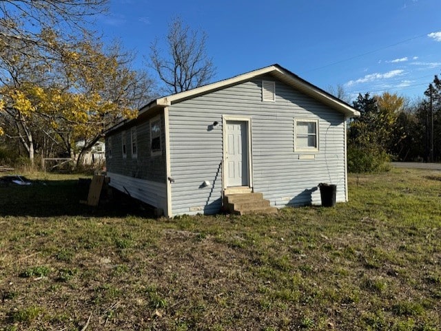 back of house with a lawn