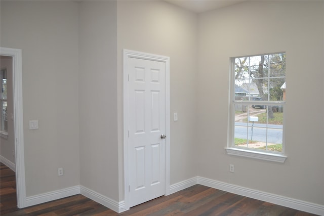 spare room featuring dark wood-type flooring