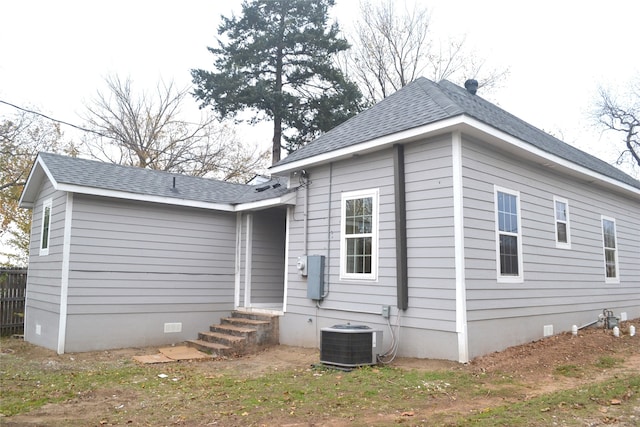 rear view of house featuring central AC