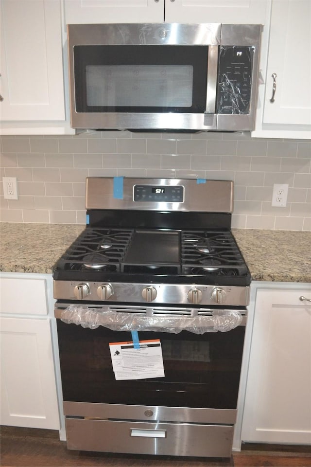 kitchen featuring stainless steel appliances and white cabinets