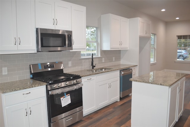 kitchen with white cabinets, appliances with stainless steel finishes, and a center island