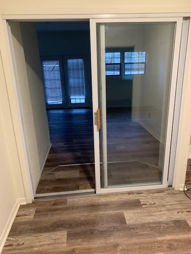 hall featuring french doors and hardwood / wood-style flooring