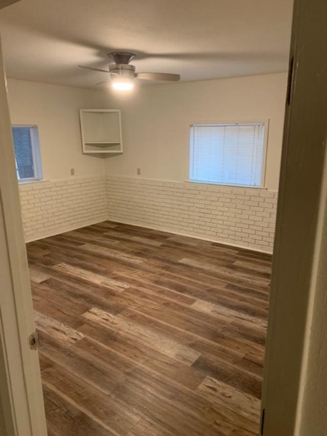 unfurnished room featuring dark hardwood / wood-style flooring and ceiling fan