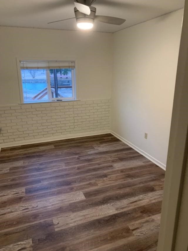 empty room featuring ceiling fan and dark hardwood / wood-style floors