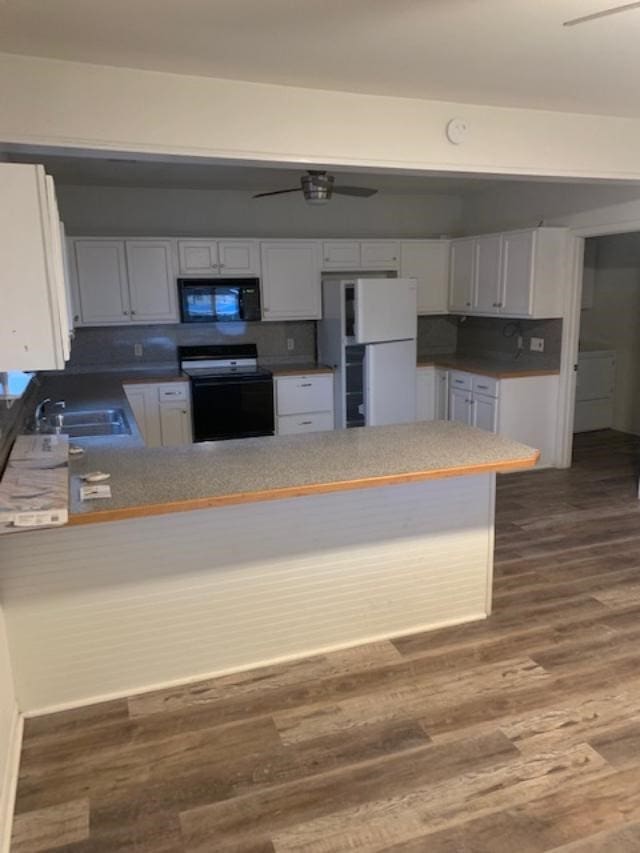 kitchen featuring white cabinets, sink, kitchen peninsula, and black appliances