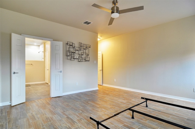 spare room with ceiling fan and hardwood / wood-style flooring