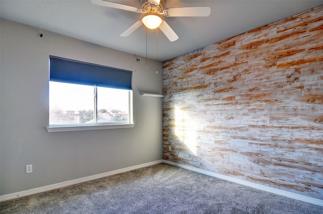 spare room featuring carpet and ceiling fan