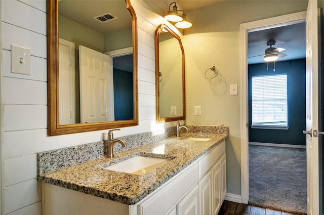 bathroom featuring ceiling fan, hardwood / wood-style floors, and vanity