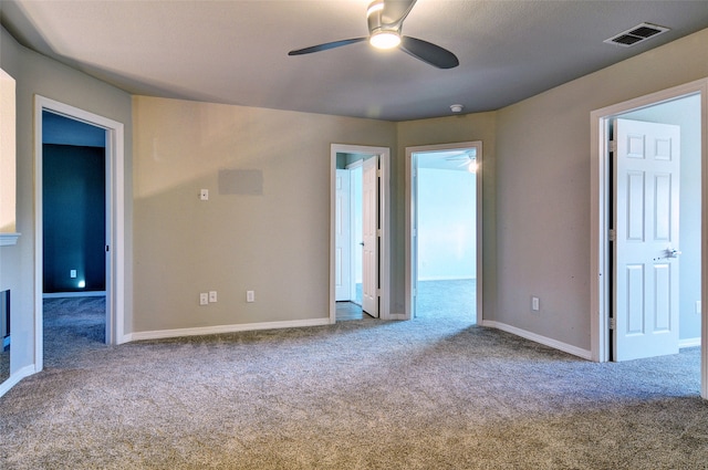 spare room featuring ceiling fan and carpet floors