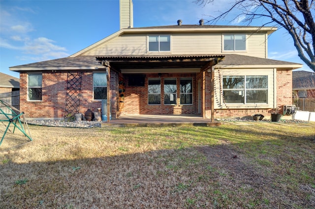 rear view of house with a yard and a patio