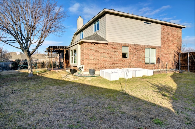 back of property featuring a lawn and a pergola