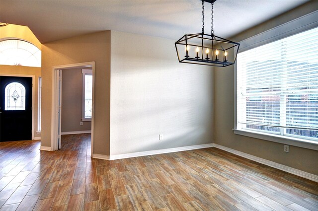 entryway with hardwood / wood-style floors and an inviting chandelier