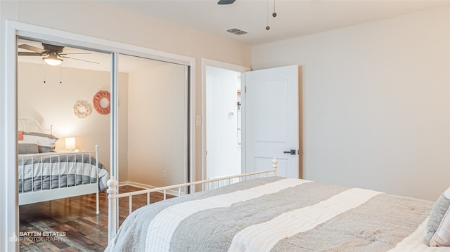 bedroom featuring ceiling fan, a closet, and hardwood / wood-style flooring