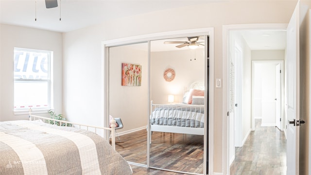 bedroom with ceiling fan, a closet, and wood-type flooring