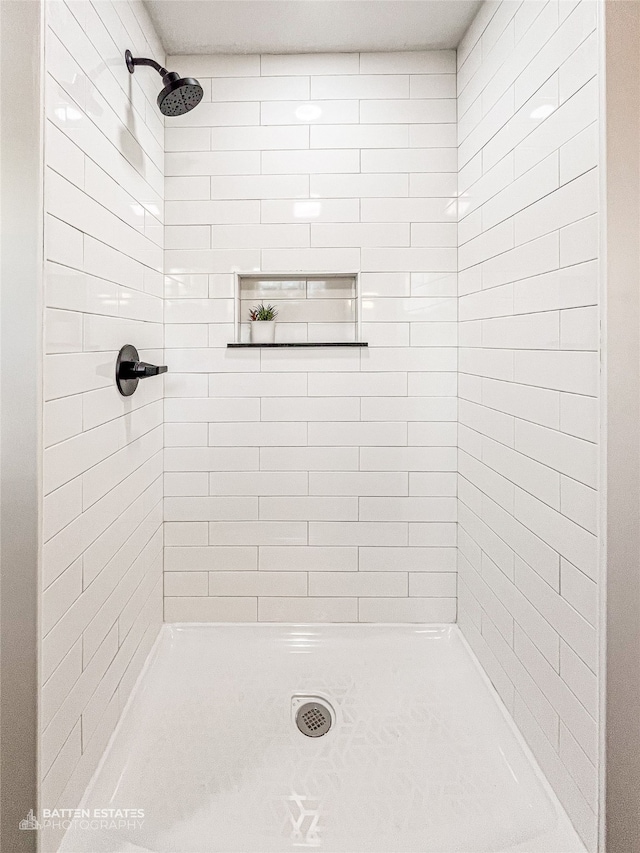 bathroom with tiled shower