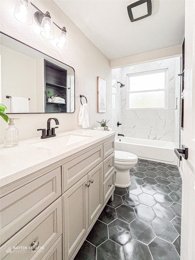 full bathroom with vanity, tiled shower / bath combo, and toilet