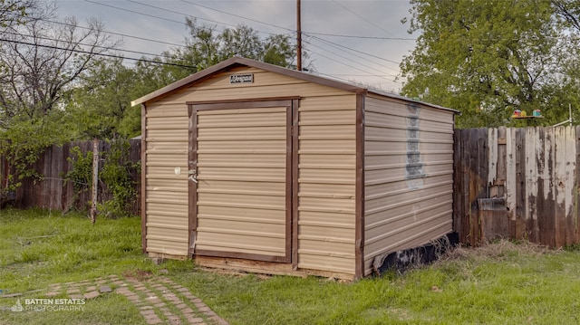 view of outbuilding featuring a lawn