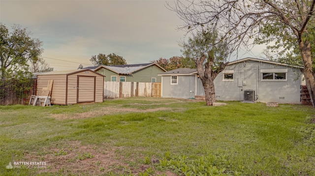 view of yard with a storage unit and cooling unit