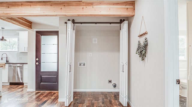 laundry room with hookup for a washing machine, dark hardwood / wood-style floors, electric dryer hookup, and sink