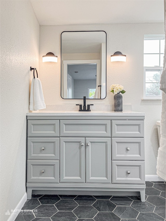 bathroom with tile patterned floors and vanity