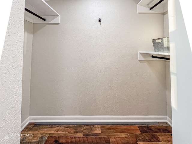 spacious closet featuring dark hardwood / wood-style flooring