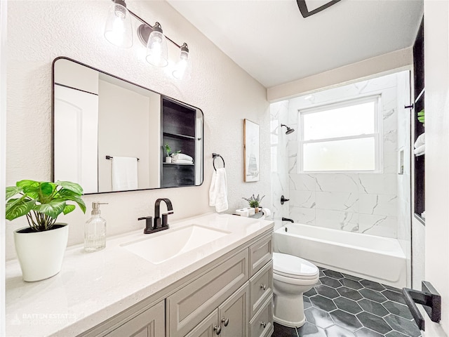 full bathroom with tile patterned flooring, tiled shower / bath combo, toilet, and vanity